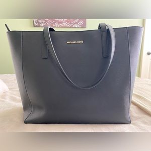 Black Michael Kors tote bag with laptop compartment.